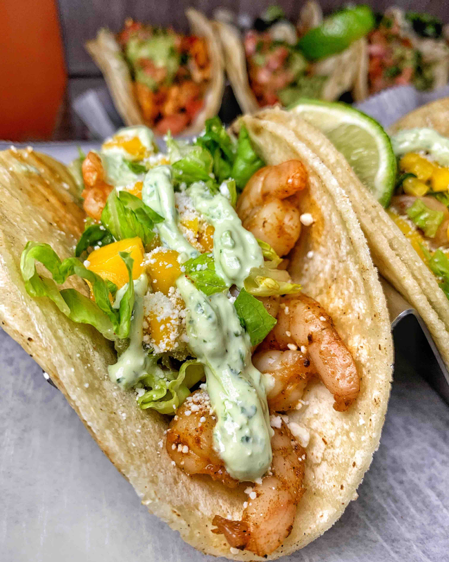 Fresh Curbside tacos topped with avocado crema